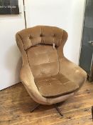 An Arne Jacobsen inspired swivel chair, with fibreglass shell and camel velour upholstery and button