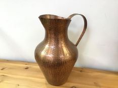 A textured copper ewer of baluster form with handle to side (42cm x 33cm x 25cm)