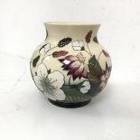 A Moorcroft squat baluster shaped vase with bramble or blackberry decoration, stamped to base (