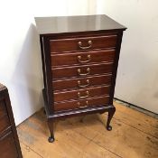 A modern mahogany sheet music cabinet, fitted six drawers each with fall front, on cabriole supports