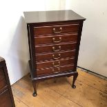 A modern mahogany sheet music cabinet, fitted six drawers each with fall front, on cabriole supports