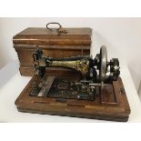 An early 20thc. Frister & Rossmann sewing machine, complete with travelling case, base bearing