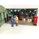 A Post Office doll's house, the well stocked interior with four figures, post box, shop counters,
