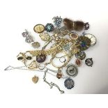 An assortment of costume jewellery including a silver thistle badge, paste and glass brooches, tie
