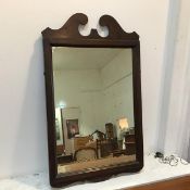 A wooden framed wall mirror, the rectangular plate in a moulded frame with swan neck crest (75cm x