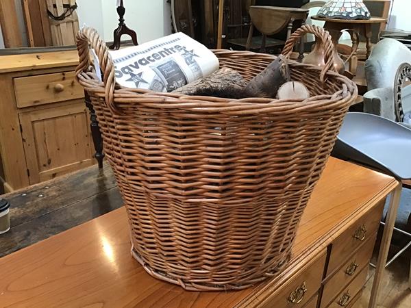 A wicker log basket with two handles and a quantity of logs (49cm x d.54cm)