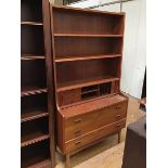 A Mobel Mann teak bookcase over desk fitted two adjustable shelves and an arrangement of drawers and