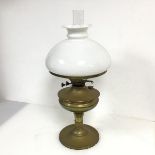 A brass paraffin lamp with internal clear glass shade marked Sunbrand, small chip and crack to