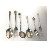 An assortment of silver spoons and forks including a London Coronation of King Edward VIII