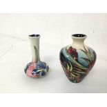 A Moorcroft bud vase of baluster form with an umbrella stamp to base (10cm) and another bud vase