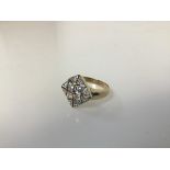 A 9ct gold dress ring with colourless stones in a pierced plaque setting (R) (3.54g)