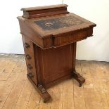 An Edwardian mahogany davenport with breakfront writing surface and dummy drawers to one side,