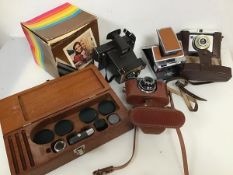 Photography interest: a Polaroid Colour Swinger land camera with original box (17cm x 17cm x