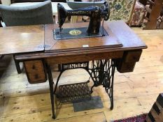 A 1930s Singer sewing machine with oak treadle table, sewing machine decoration in an Egyptian