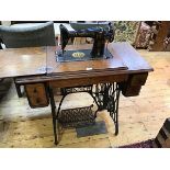 A 1930s Singer sewing machine with oak treadle table, sewing machine decoration in an Egyptian