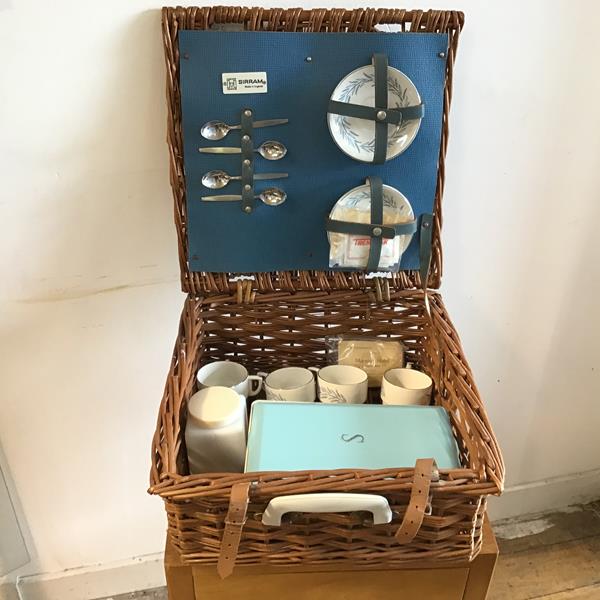 A Sirram picnic basket, stamped Hawker Marris complete with four teacups and saucers, teaspoons,