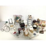 A collection of dolls' house furniture and homewares including garden chairs, barbeque, swing,