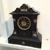 A Victorian slate mantel clock of architectural form, with foliate decoration and agate panels (49cm