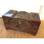 A Chinese camphorwood chest with allover carved Chinese scenes, interior with two sliding trays,
