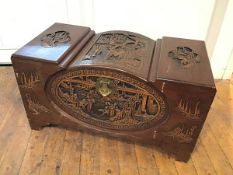 A Chinese camphorwood chest with allover carved Chinese scenes, interior with two sliding trays,