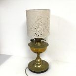 A converted brass paraffin table lamp with perforated shade (h. to top of shade: 51cm x d. at