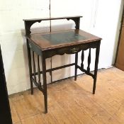 A 1920s/30s oak writing table with slightly slanting top above a single frieze drawer on straight