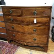 A Regency mahogany and ebony lined bow front chest, the rectangular top above two short and three