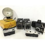 A collection of Kodak cameras including a brownie type C (11cm x 12cm x 7cm), a brownie type E and a