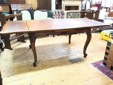 A modern oak extendable dining table with two pull out leaves, on carved base with cabriole legs (