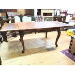 A modern oak extendable dining table with two pull out leaves, on carved base with cabriole legs (