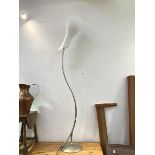 A modern standard lamp with a S scroll stem on circular base, complete with a tulip style opaque