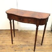 A reproduction mahogany serpentine hall table, the crossbanded top above a pair of frieze drawers,