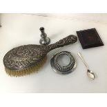 A mixed lot including an Edwardian Sheffield silver backed hairbrush (26cm x 9cm), a taper stick,