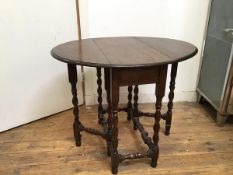 A 1920s/30s oak gateleg occasional table on barley twist supports united by turned stretchers (