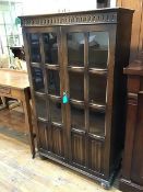 A 1920s/30s oak bookcase, the cornice with moulded frieze above a pair of doors, each with six glass