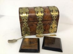 A 19thc. walnut dome top brass bound tea caddy (17cm x 23cm x 13cm) (a/f) and two caddy spoons,