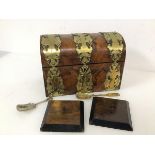 A 19thc. walnut dome top brass bound tea caddy (17cm x 23cm x 13cm) (a/f) and two caddy spoons,