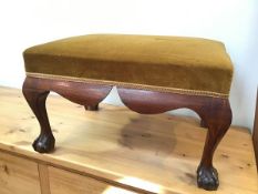A reproduction Georgian mahogany footstool with mustard brown upholstered top, with moulded