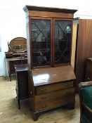 An Edwardian mahogany bureau bookcase, crack to central glass panel of one door, interior with an