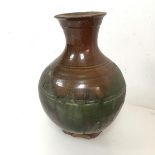 A brown and green glazed vase of baluster form, possibly Chinese (a/f) (21cm x 14cm)