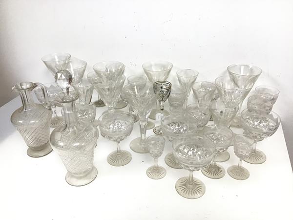 An assortment of cut glass and crystal stemware including sherry glasses, cocktail glasses etc., a
