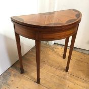 A small George III style satinwood and mahogany demi lune card table c.1900, the foldover top with