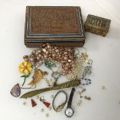 An assortment of costume jewellery including paste pearls, brooches, enamelled flower brooch,