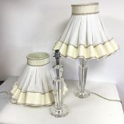 A pair of faceted baluster style table lamps, one marked crystal, complete with ruffled lampshade (