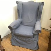 A modern wing back armchair with later blue upholstery, with front turned mahogany supports united