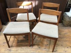 A set of four 1960s Mackintosh teak dining chairs with convex backs above upholstered seats with