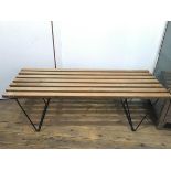 A 1960s slatted bench or low table, with black painted metal angular rod base (a/f) (41cm x 121cm