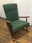 A 1970s teak rocker, with green foliate design upholstered back and cushion (87cm x 64cm x 100cm)