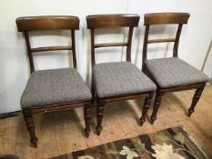 A set of three mid 19thc mahogany side chairs with herringbone upholstered drop in seats on turned