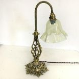 An Edwardian brass lamp, the moulded neck on twisted body with foliate base, with vaseline glass